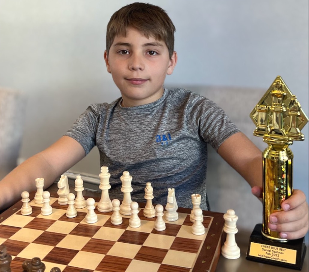 Daniel, Age 11, MyChessCoach student holding a chess tournament trophy