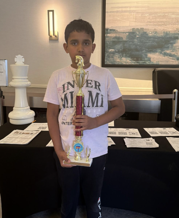 Viaan, Age 9, MyChessCoach student holding a chess tournament trophy